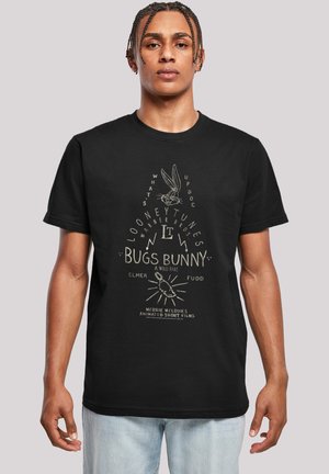 Sort bomulds T-shirt med et Bugs Bunny grafik i beige med tekstelementer, rund hals, korte ærmer og en afslappet pasform.