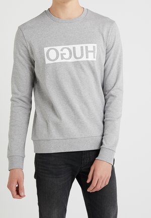 Gray cotton sweatshirt with long sleeves, round neckline, and a white "HUGO" logo across the front; features ribbed cuffs and hem.