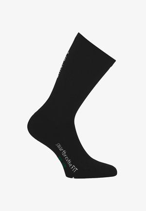 Zwarte kniehoge sok gemaakt van zacht materiaal, met ribbeltextuur, versterkte hiel en witte logodetail aan de zijkant.