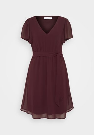 Bordeaux kjole lavet af letvægtigt stof, med V-udskæring, korte puffærmer, snøret talje og en bundet bælte. Blød A-linje silhuet.