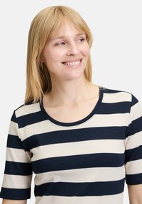 Striped shirt featuring navy blue and cream horizontal stripes, ribbed texture, crew neck, and short sleeves.