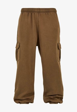 Bruna sweatpants gjorda av mjukt material med en lös passform, utrustade med elastisk midja, smalnande ärmslut och sidofickor.