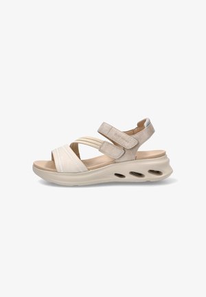 Sandalia beige de mujer con correas ajustables, suela acolchada y orificios de ventilación en la entresuela para mayor comodidad y transpirabilidad.