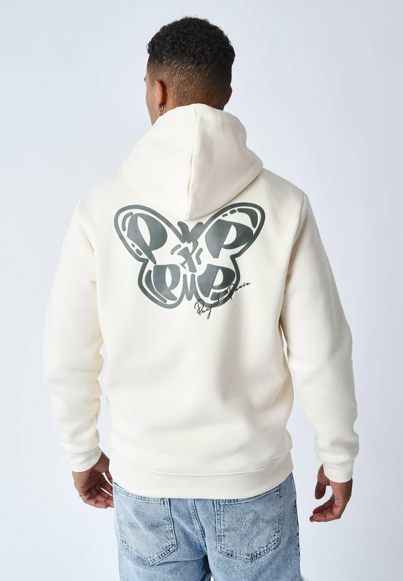 Sudadera crema con un gran gráfico de mariposa negra en la parte posterior, bolsillo tipo canguro y capucha con cordón; hecha de una suave tela texturizada.