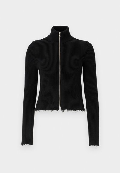 Black ribbed cropped jacket with a high collar and a front zipper. Features frayed hem and long sleeves, made from textured knit material.