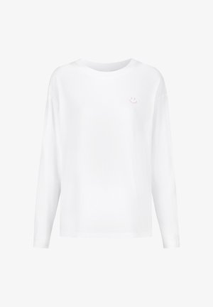Wit shirt met lange mouwen gemaakt van katoen. Voorzien van een kleine roze smiley-print op de linkerborst. Eenvoudige, ontspannen pasvorm.