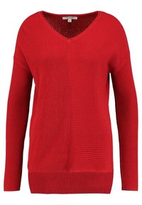 Pull en tricot rouge avec un décolleté en V, des manches longues, un motif de côtes texturé et une coupe décontractée.