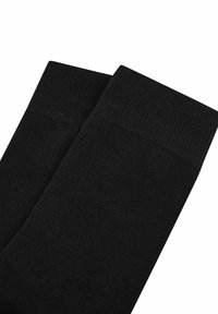 Schwarze Socken aus einem weichen, strukturierten Stoff. Sie verfügen über einen gerippten Bund an der Oberseite, der einen engen Sitz bietet.