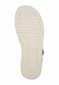 Podešev boty s texturovaným, vroubkovaným designem; světle krémová barva; kruhové logo se symbolem "+" poblíž paty; plochá a flexibilní konstrukce.