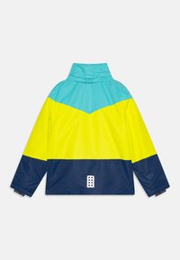 Vízálló dzseki színek blokkolt kialakítással türkiz, sárga és tengerészkék színekben. Magas gallérral és egy fehér logóval a hátoldalon.