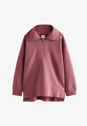 Waffelstrukturierter, rosafarbener Pullover mit einem halben Reißverschluss und großem Kragen. Seitenaschlüsse am Saum für eine entspannte Passform.