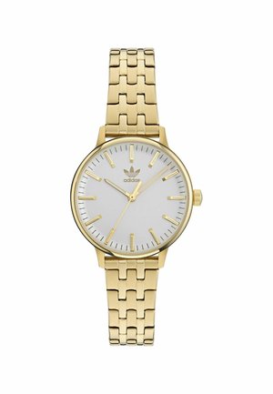 Montre-bracelet dorée avec un cadran blanc lisse, des index dorés fins, trois aiguilles et un bracelet en maillons métalliques dorés. Logo de la marque sur le cadran.