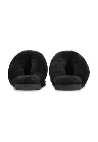 Black faux fur slippers with a cushioned interior and flat, textured rubber sole. Open back design and soft, fluffy material.