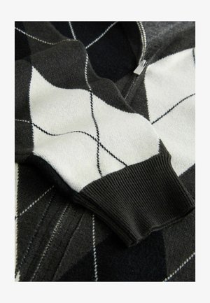 Fekete-fehér rombusz mintás pulóver, könnyű textúrával, cipzáras záródással és bordás mandzsettával, kontrasztos varrási részletekkel.