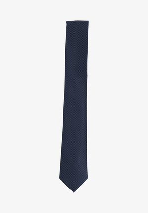 Navy blue patterned tie with a diamond texture. Slim design with pointed tip. Made of a smooth woven fabric. No visible hardware or accents.