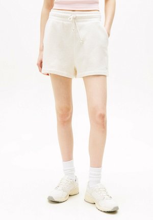 Helle beige Baumwollshorts mit einem elastischen Bund, Kordelzug und seitlichen Taschen. Sie verfügen über eine glatte Textur und ein lässiges Design.