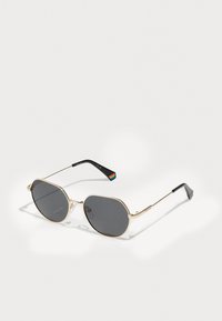 Gold metal sunglasses with gray lenses, an octagonal shape, thin temples, and a multicolored striped detail on the inner arm.