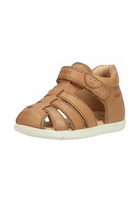 Light brown toddler sandal with closed toe, multiple leather straps, velcro ankle strap, and white rubber sole.