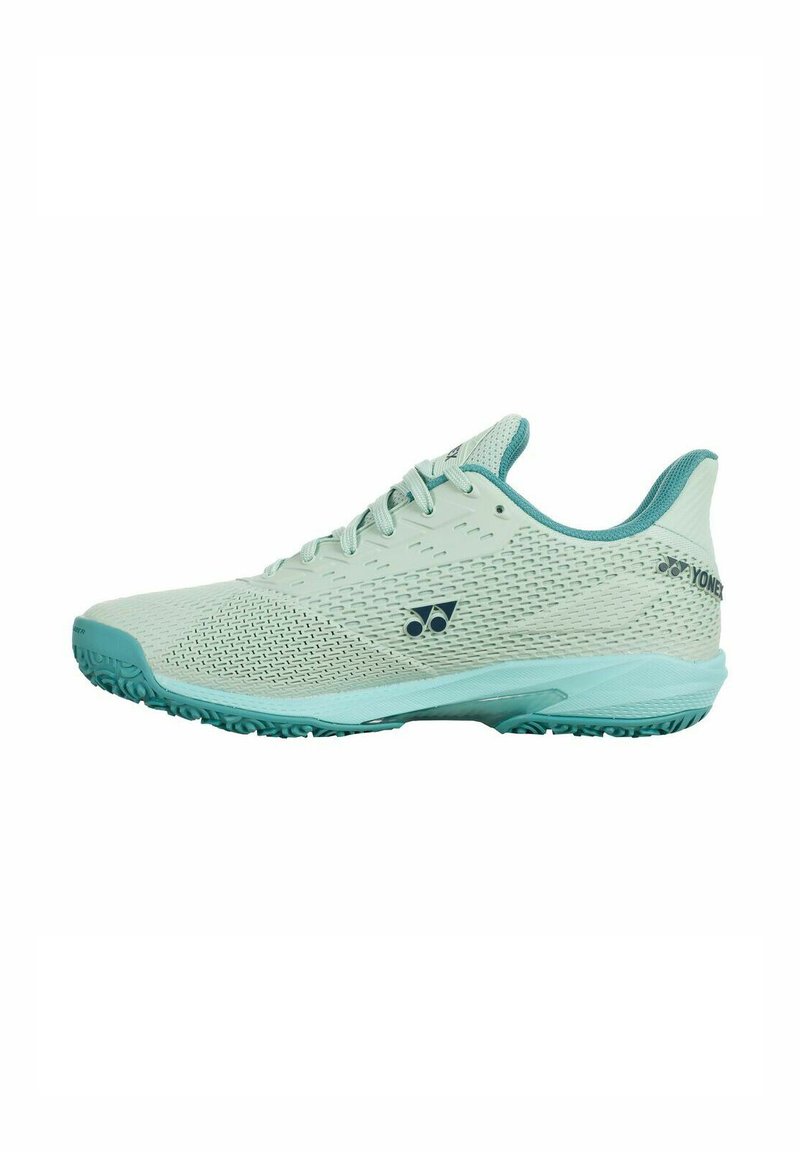 Light green athletic shoe with a mesh upper, curved design, textured sole, flat laces, and accent logo on the side. Durable rubber outsole.