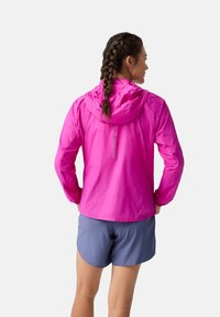 Lightweight, hooded jacket in vibrant pink with a smooth texture. Features elastic cuffs and a visible logo on the back. Paired with gray shorts.