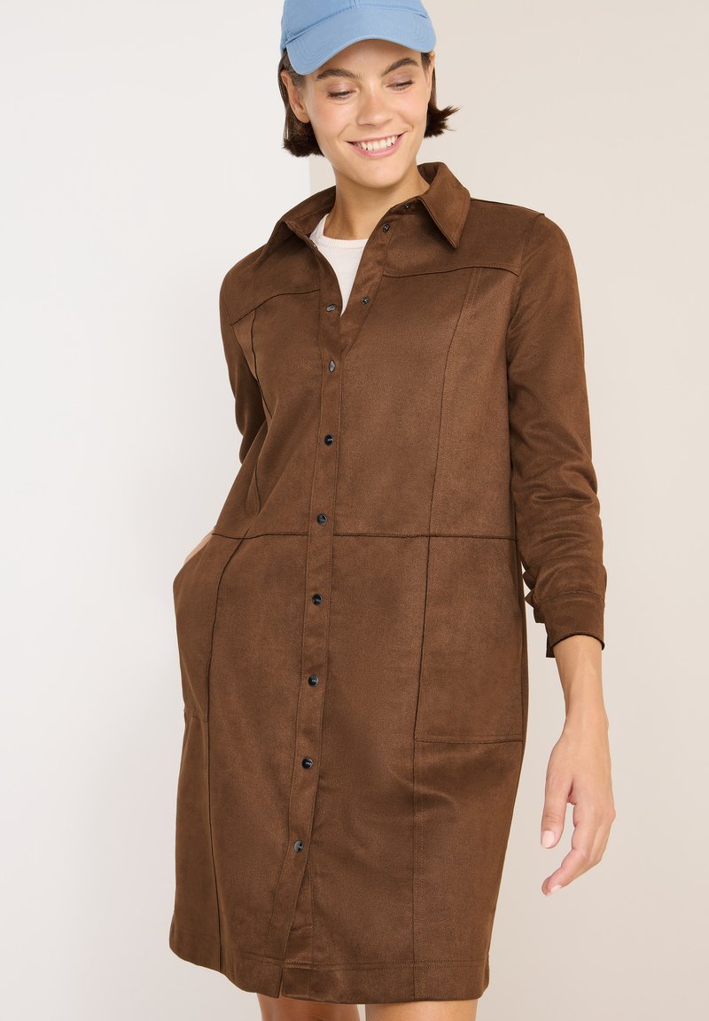 Abito button-up marrone realizzato in un morbido tessuto simile alla pelle scamosciata. Caratterizzato da maniche lunghe, due tasche laterali e cuciture a contrasto per un dettaglio di design.