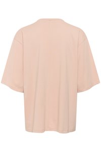 Kortermet, oversized skjorte i myk rosa stoff med rund hals og rett kant, med minimale sømmer på baksiden.
