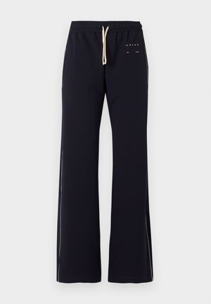 Black wide-leg pants with beige drawstring waist and subtle white side stripes, featuring small white text near the left pocket.