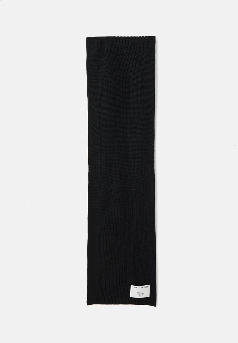 Black knitted scarf with a white rectangular label featuring "Tiger of Sweden" text and a tiger logo on a white background.