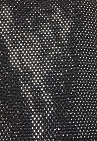 Black mesh fabric adorned with small, shiny circular sequins, creating a sparkling effect across the surface with a smooth texture.