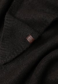 Dark brown wool sweater with a soft texture, featuring a folded collar and a small brown leather tag with a logo.