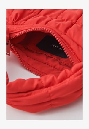 Rode, donsachtige stoffen tas met een gequilt ontwerp, voorzien van een ritssluiting en een gladde binnenvoering. Inclusief een zichtbaar merketiket.