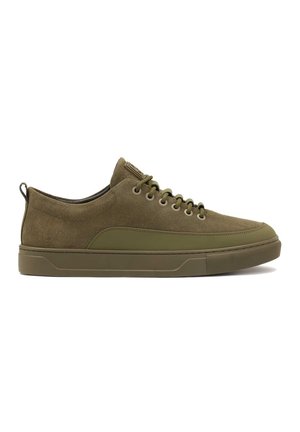 Zapatillas de ante verde oliva con suela de goma a juego, punta redonda y seis pares de ojales; cuenta con una pestaña en la parte trasera para facilitar su puesta.