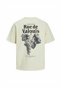 Krémové tričko s ilustrací hroznu a textem "Rue de Valouis" v tučném černém písmu na zadní straně. Krátké rukávy, uvolněný střih.