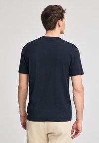 Camiseta de hombre de manga corta en algodón color azul marino, con cuello redondo y una textura suave, sin patrones ni logos visibles.