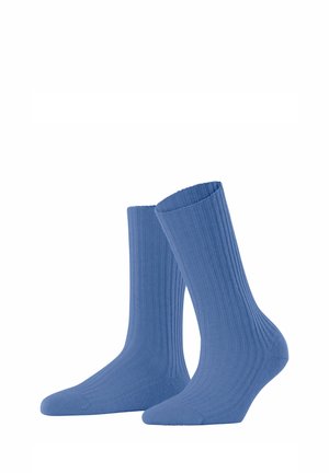 Chaussettes bleu ribblées avec une texture douce, présentant un design mi-mollet et un orteil renforcé. Conçues pour le confort et la durabilité.