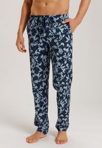 Pantaloni del pigiama blu navy con un motivo floreale in azzurro chiaro. Realizzati in morbido tessuto, presentano una vita elastica con cordoncino.