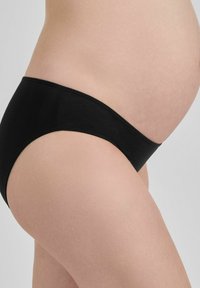 Juodos nėštumo kelnaitės su lygiu, tamprių audiniu, sukurtos patogumui ir palaikymui. Žemas kirpimas su besiūle juosta.