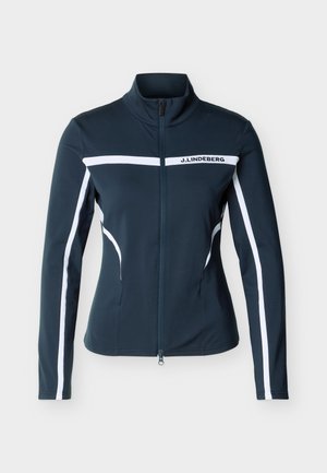 Jachetă bleumarin cu fermoar, dungi albe pe mâneci și piept, croială mulată, guler înalt și logo-ul "J. LINDEBERG" pe banda de pe piept.