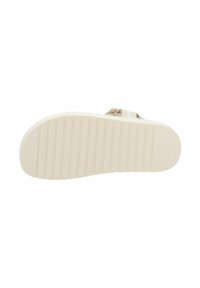 Suola di scarpa in gomma beige chiaro con righe orizzontali per una migliore aderenza, caratterizzata da una superficie texturizzata e un tacco leggermente rialzato per stabilità.