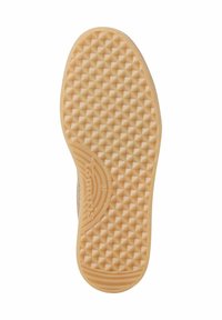Suola di scarpa in gomma con una superficie testurizzata e decorata da piccole forme a piramide, di colore beige chiaro. Logo e taglia stampati sul lato.