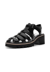 Black leather sandal with wide woven straps, open toe, and adjustable ankle buckle. Features a chunky, serrated sole for traction.