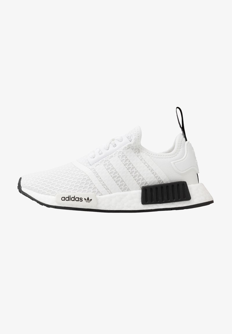 White Adidas NMD sneaker with black sole accents, mesh upper, three stripes on sides, and black pull tab on heel.