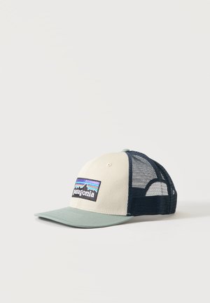 Baseballkasket med beige front, grøn skygge, marineblåt netbagstykke og Patagonia-logoemblem med bjerge og en farverig himmel.