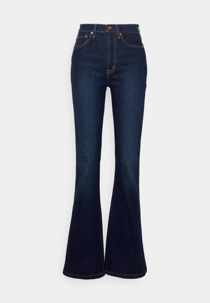 Dark blue flared jeans made of denim with a high waistband, featuring contrasting orange stitching and straight cut from knee to hem.