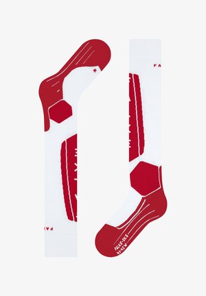 Calzini rossi e bianchi con motivi esagonali, texture a coste sulla parte del piede e un logo. Il design è adatto per l'uso atletico.