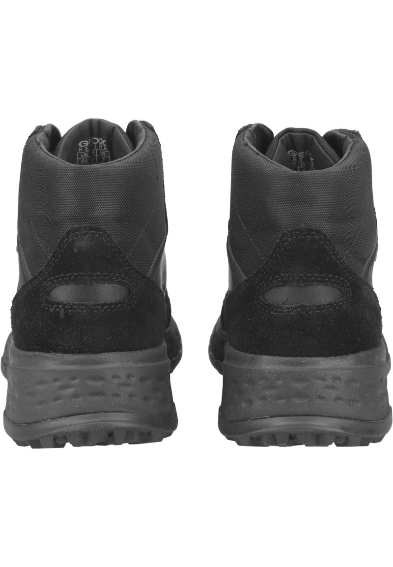 Schwarze Stiefeletten mit einer Kombination aus glattem Stoff und Wildleder. Rund geformter Absatz, strukturierte Sohle und minimales Design ohne sichtbare Logos.