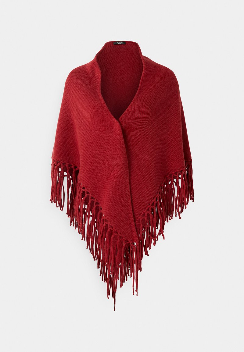 Red knitted poncho with a V-neck design and long fringed edges, featuring a soft texture and even color throughout.
