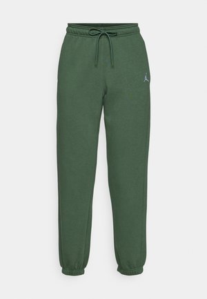 Pantalones de chándal verdes hechos de un tejido suave, con una cintura ajustable con cordón, puños elásticos y un pequeño logotipo en la parte superior de la pierna izquierda.