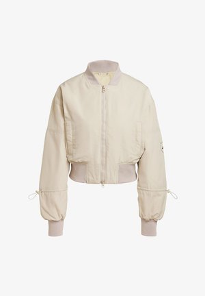 Chaqueta bomber beige recortada con cierre de cremallera, cuello y puños acanalados, y detalles de cuerda en las mangas. Presenta un bolsillo lateral.