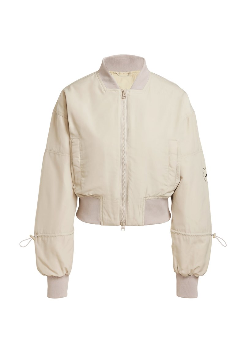 Geknipte beige bomberjack met een ritsafsluiting, ribgebreide kraag en manchetten, en trekkoorddetails op de mouwen. Beschikt over een zijzak.